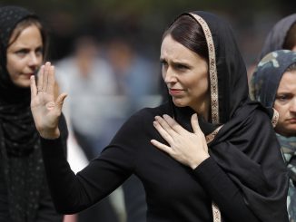 FILE - In this March 22, 2019, file photo, New Zealand Prime Minister Jacinda Ardern, center, waves as she leaves Friday prayers at Hagley Park in Christchurch, New Zealand. A comprehensive report released Tuesday, Dec. 8, 2020 into the 2019 Christchurch mosque shootings in which 51 Muslim worshippers were slaughtered sheds new light on how the gunman was able to elude detection by authorities as he planned out his attack. (AP Photo/Vincent Thian, File)