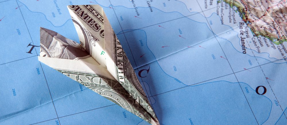 Paper plance on travel map symbolizing and expensive journey