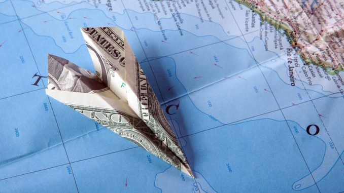 Paper plance on travel map symbolizing and expensive journey